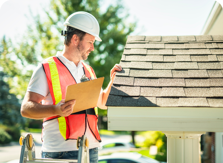 Builder checking roof condition with clipboard