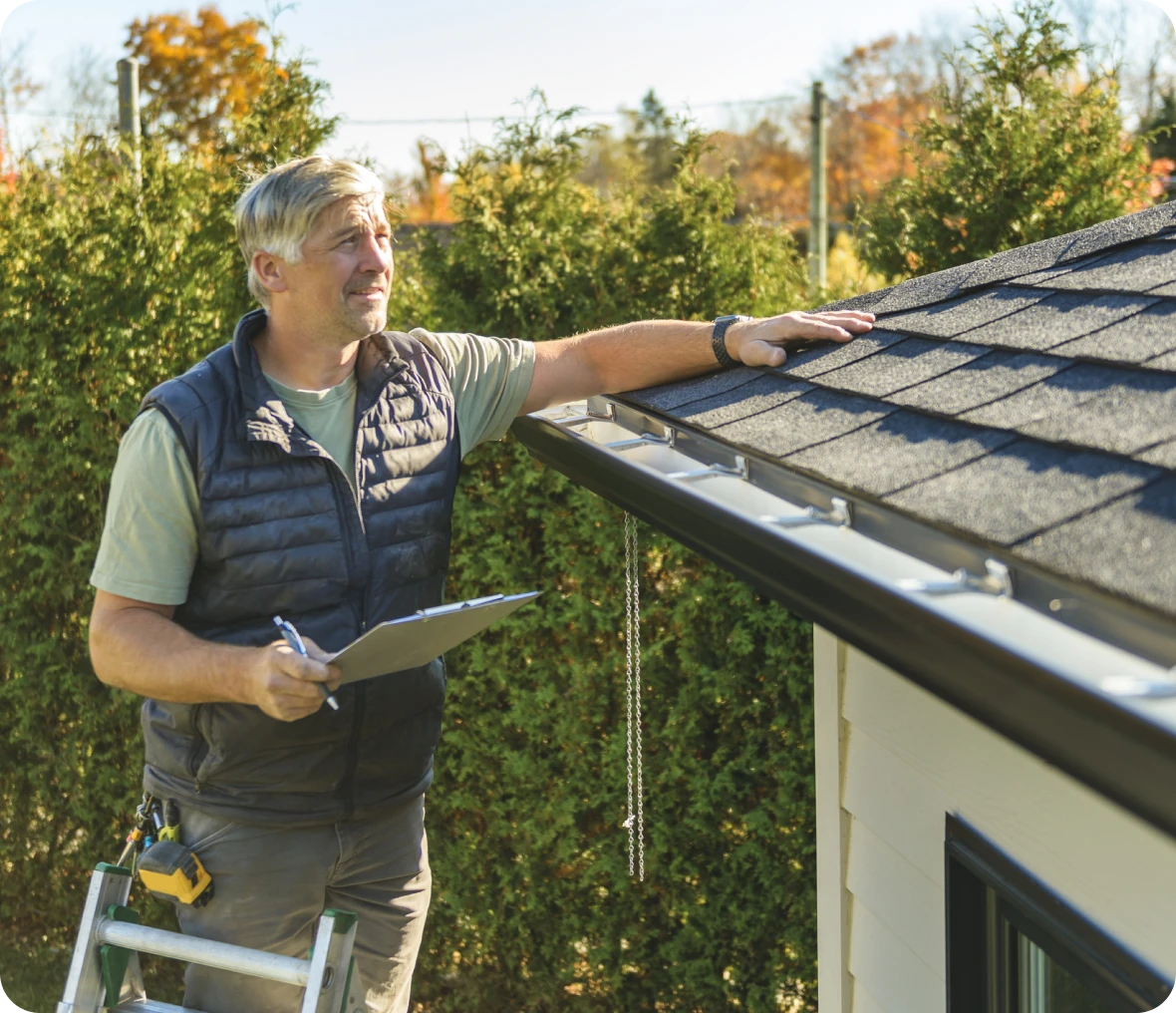 Home inspector on ladder outside