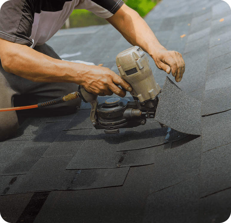 Worker securing roof with power tool