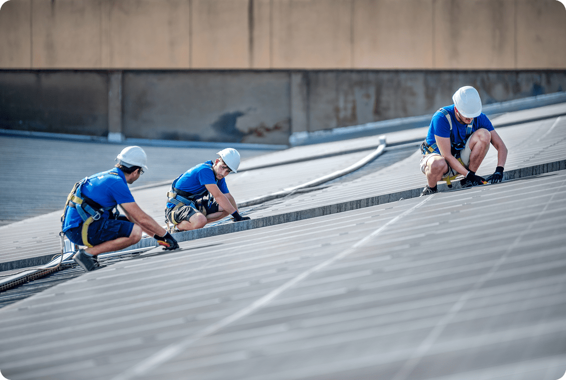 Team repairing industrial roof structure