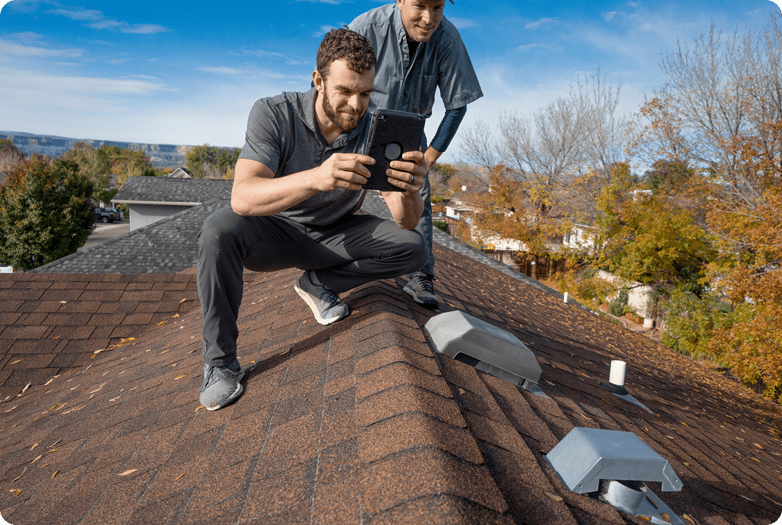 Men examining rooftop condition