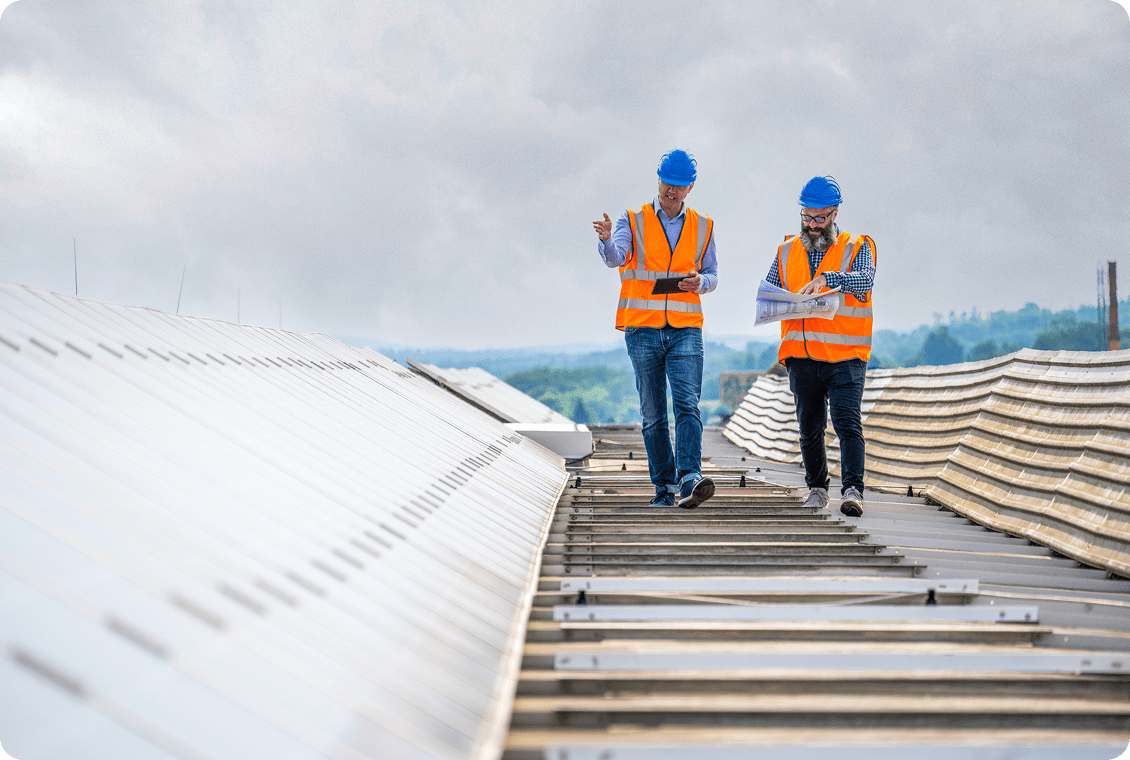 Engineers in safety vests on roof
